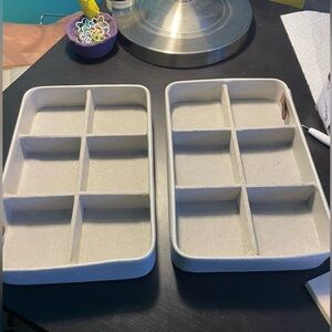 Two gray velvet jewelry display cases